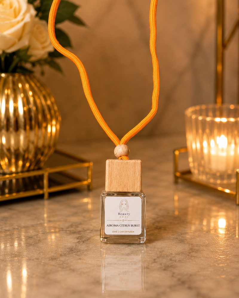 Beauty Luxe Airoma Citrus Burst 10ml car diffuser with a wooden cap and orange cord.