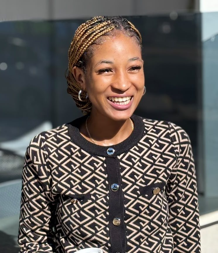 The founder of Beauty Luxe, smiling in warm daylight.